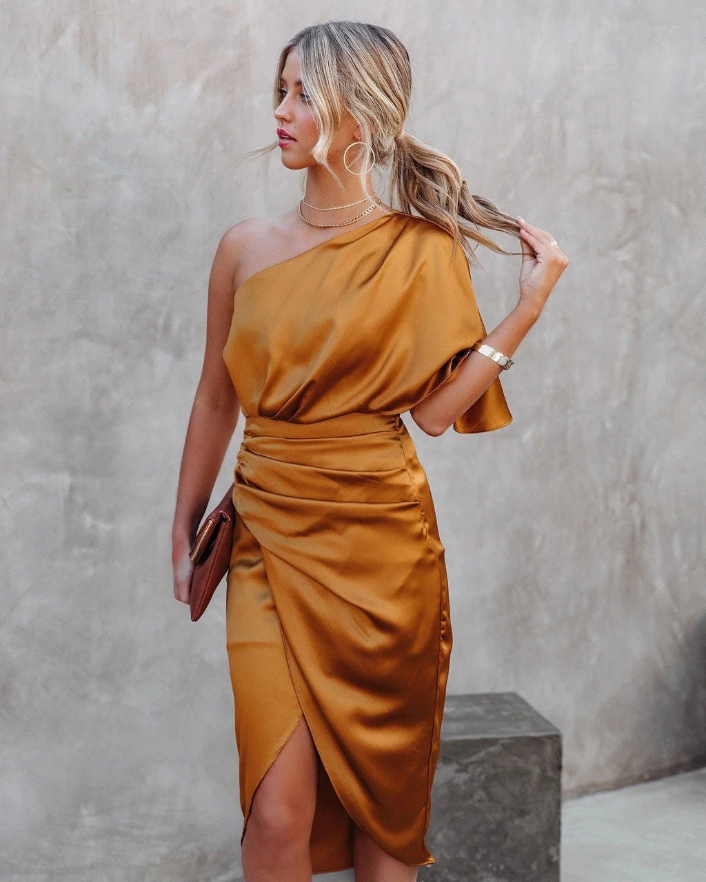 Woman wearing a one shoulder satin cocktail dress with ruched waist and wrap-front split midi skirt - view 6