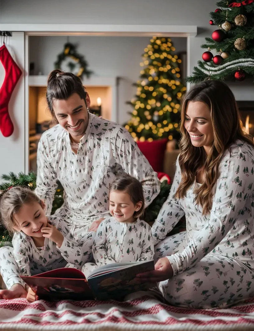 Matching family Christmas pyjamas with green watercolour tree print on white