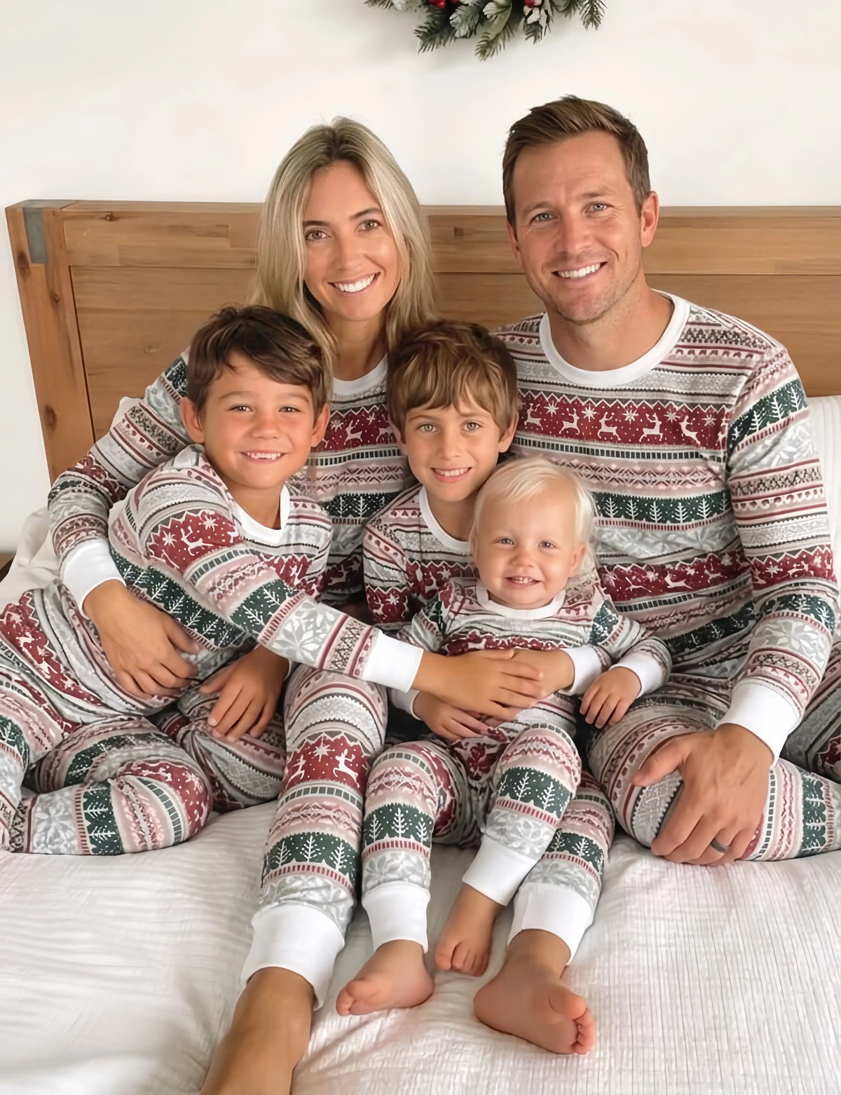 Family wearing matching Fair Isle Christmas pyjamas with reindeer and snowflake print