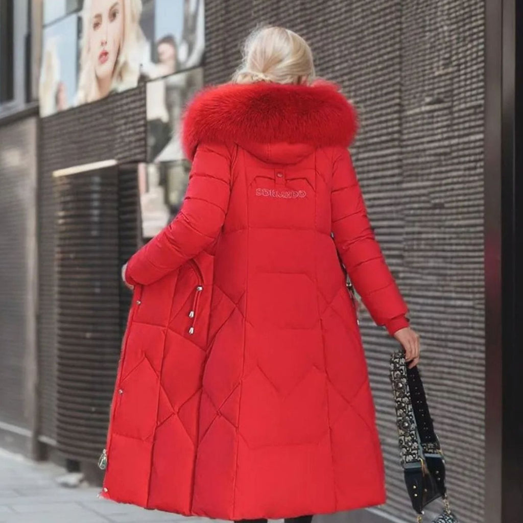 Woman wearing a long cream quilted winter coat with faux fur trimmed hood - view 14