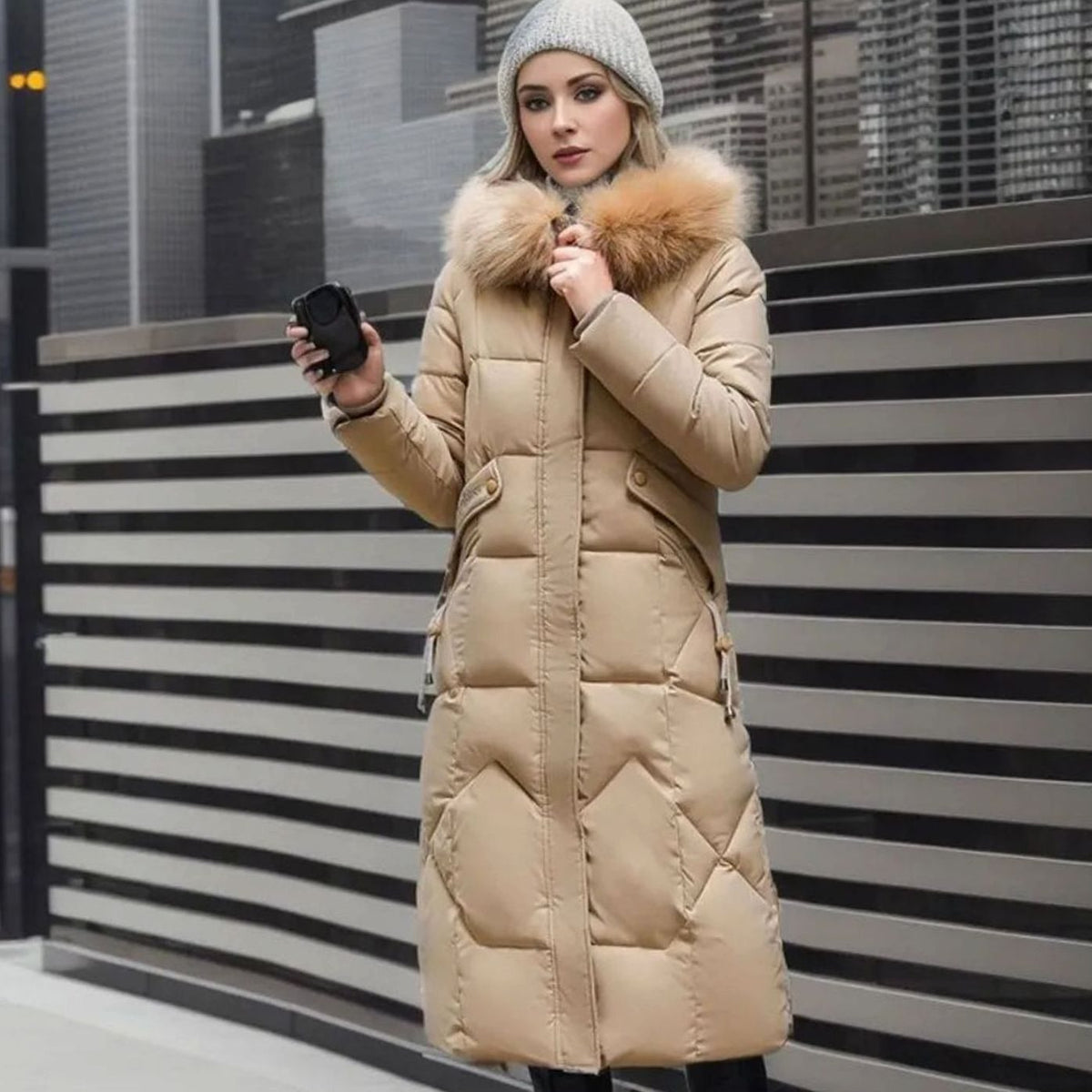 Woman wearing a long cream quilted winter coat with faux fur trimmed hood - view 17