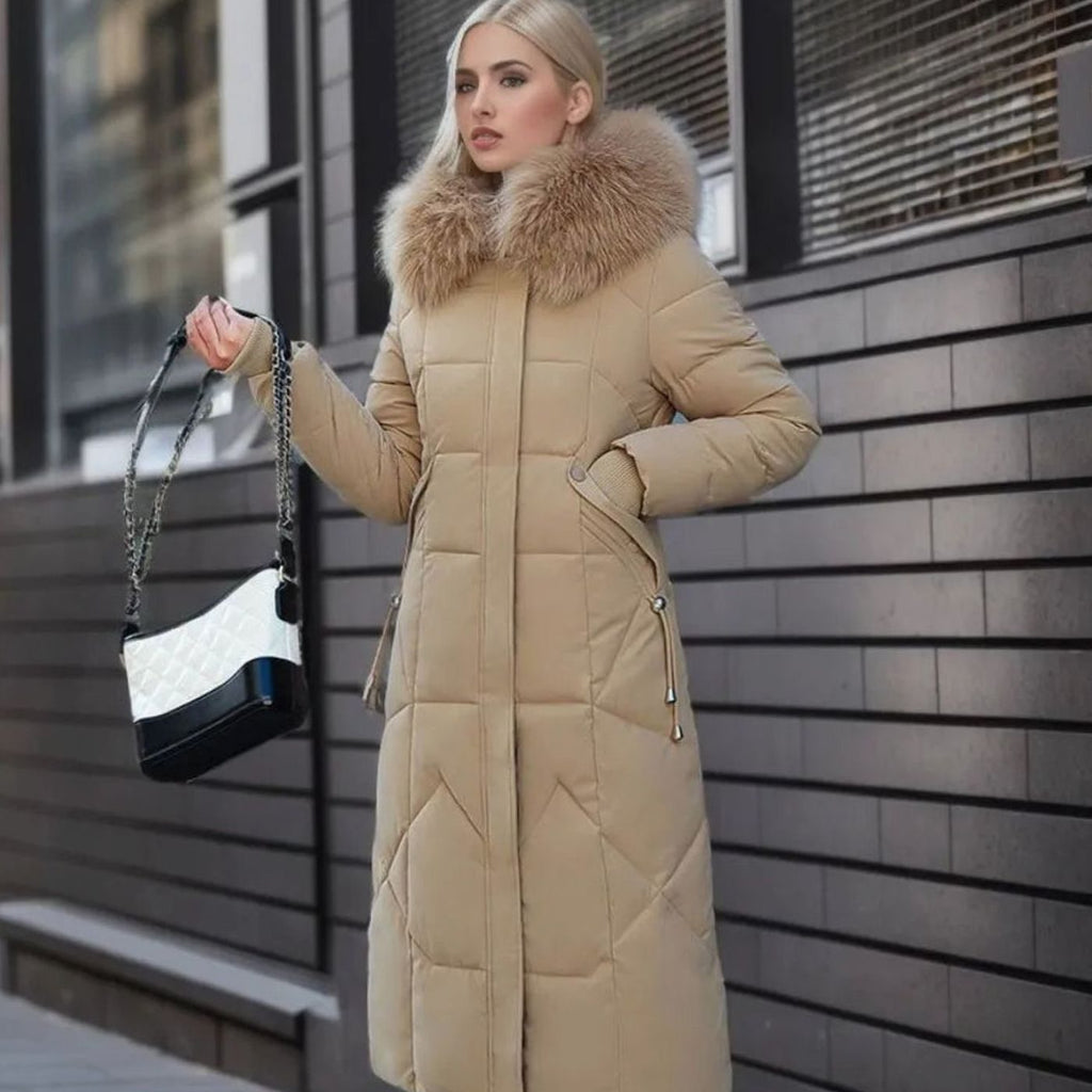 Woman wearing a long cream quilted winter coat with faux fur trimmed hood - view 19