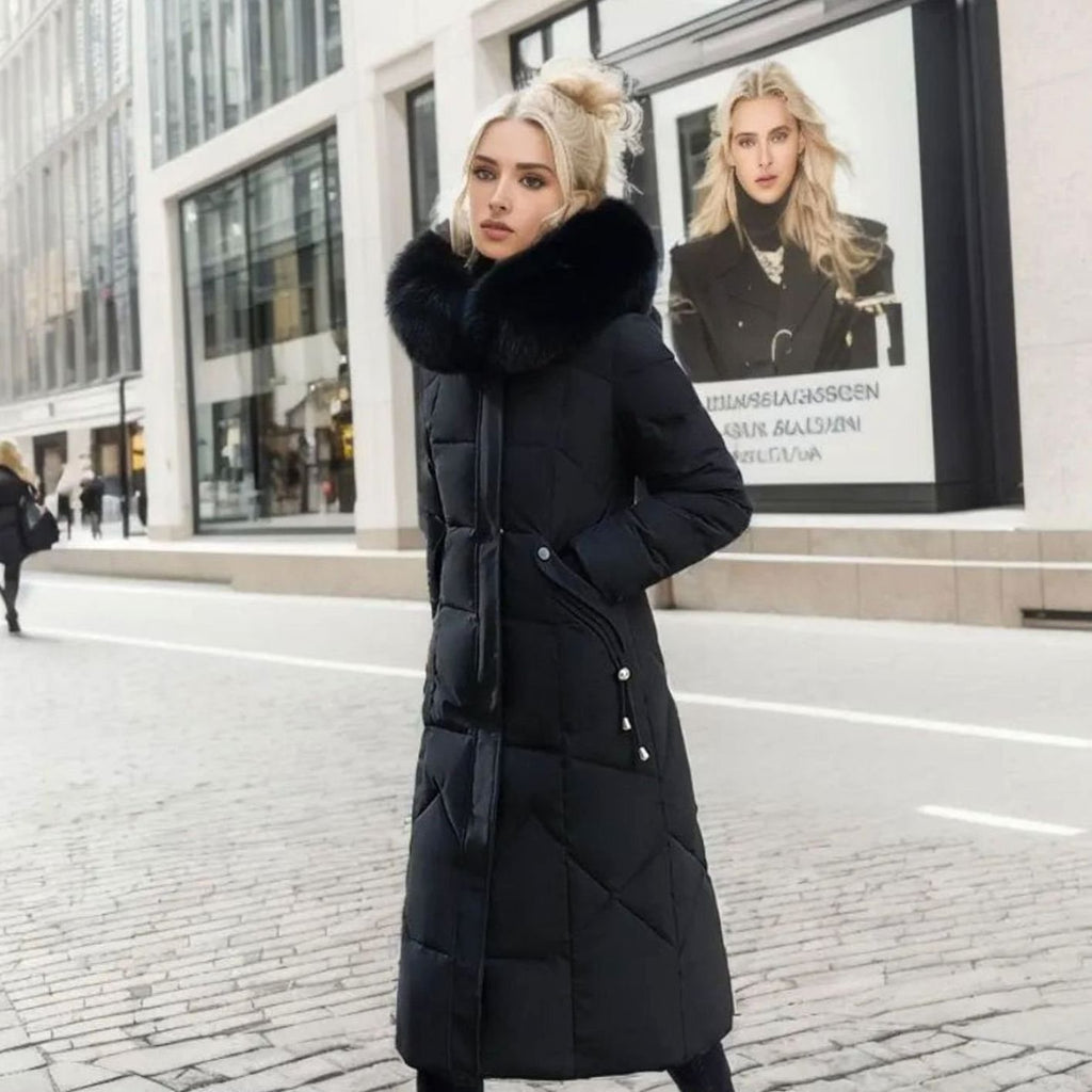 Woman wearing a long cream quilted winter coat with faux fur trimmed hood - view 8