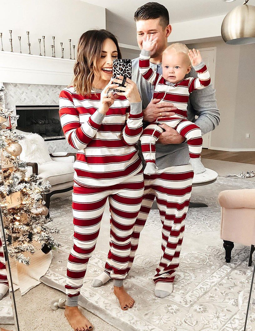 Family wearing matching red and white striped Christmas pyjamas with grey cuffs - view 11