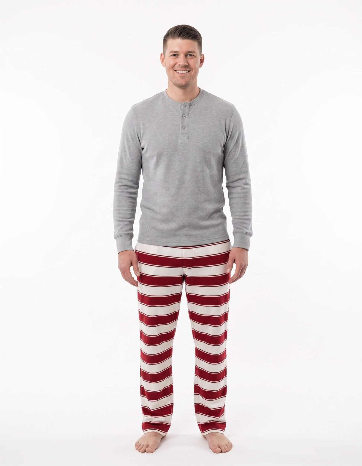 Family wearing matching red and white striped Christmas pyjamas with grey cuffs - view 7