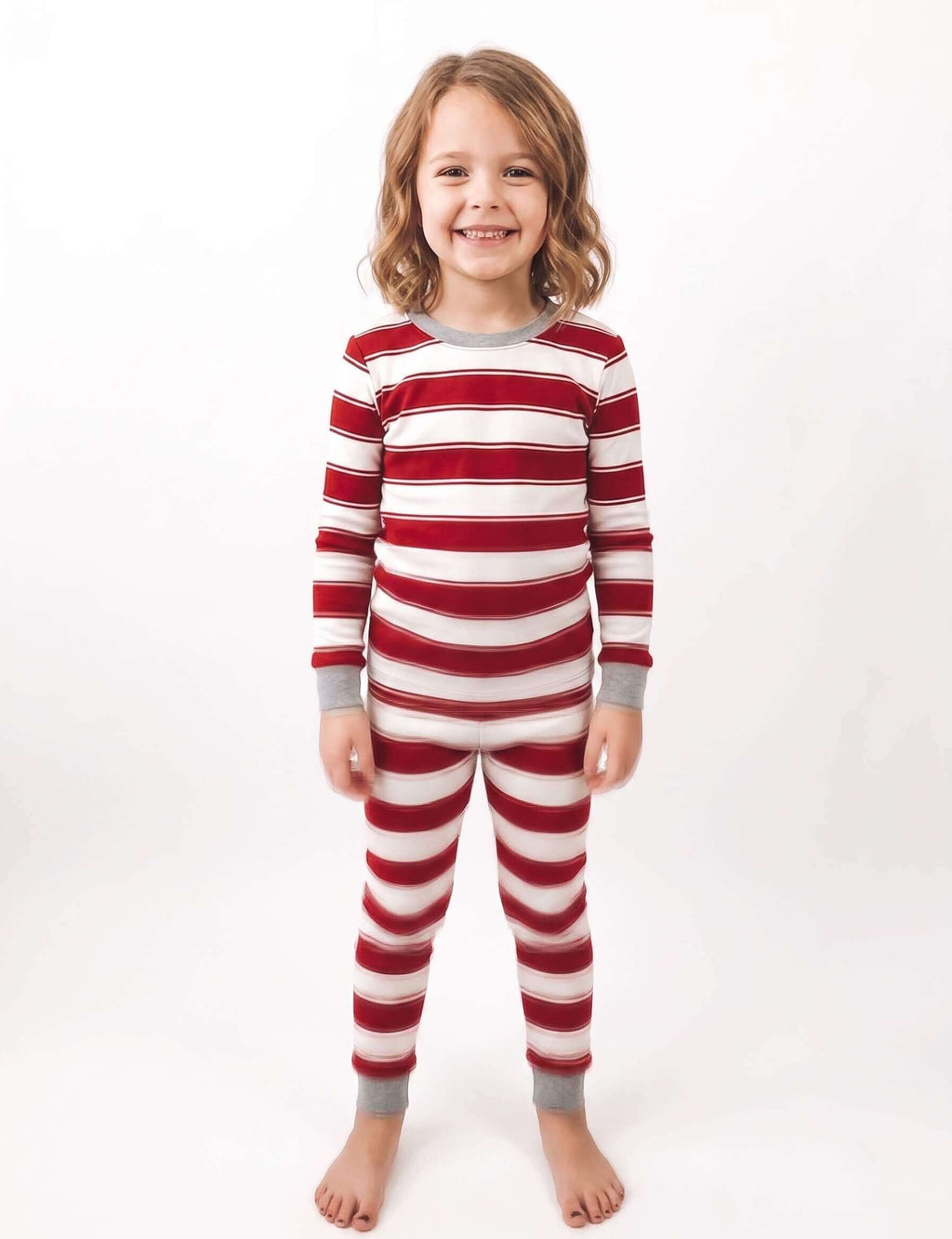Family wearing matching red and white striped Christmas pyjamas with grey cuffs - view 9