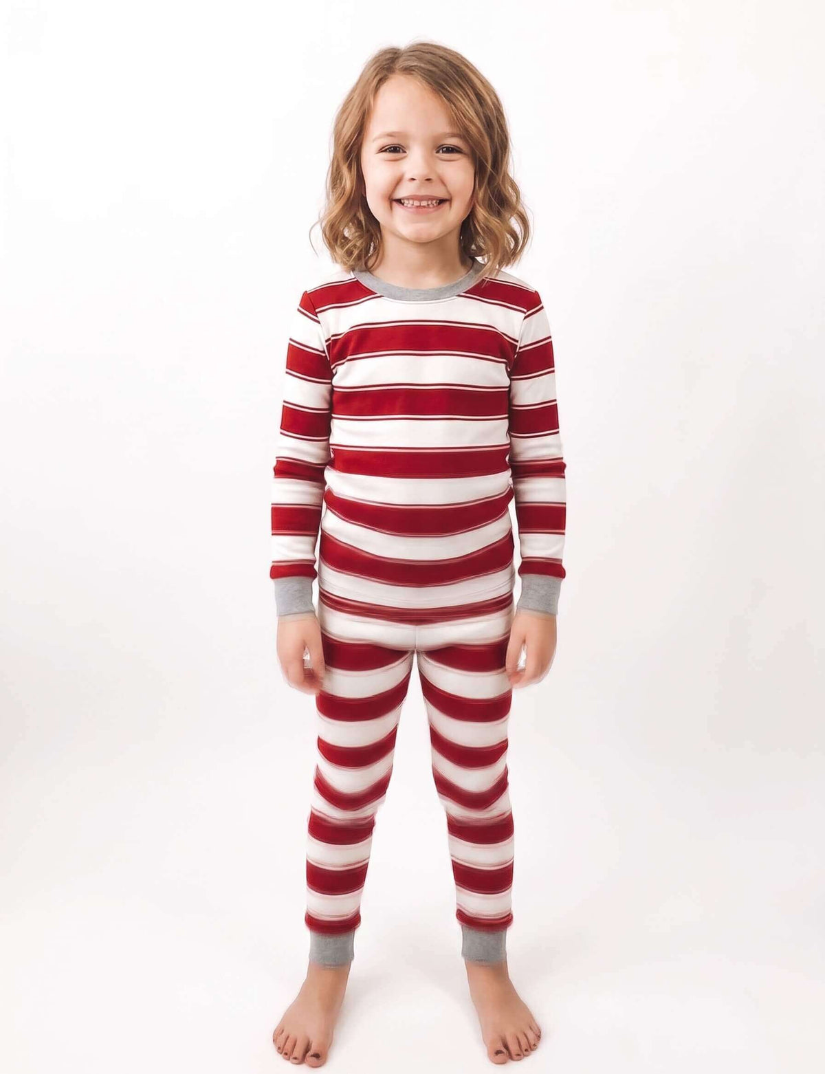 Family wearing matching red and white striped Christmas pyjamas with grey cuffs - view 9