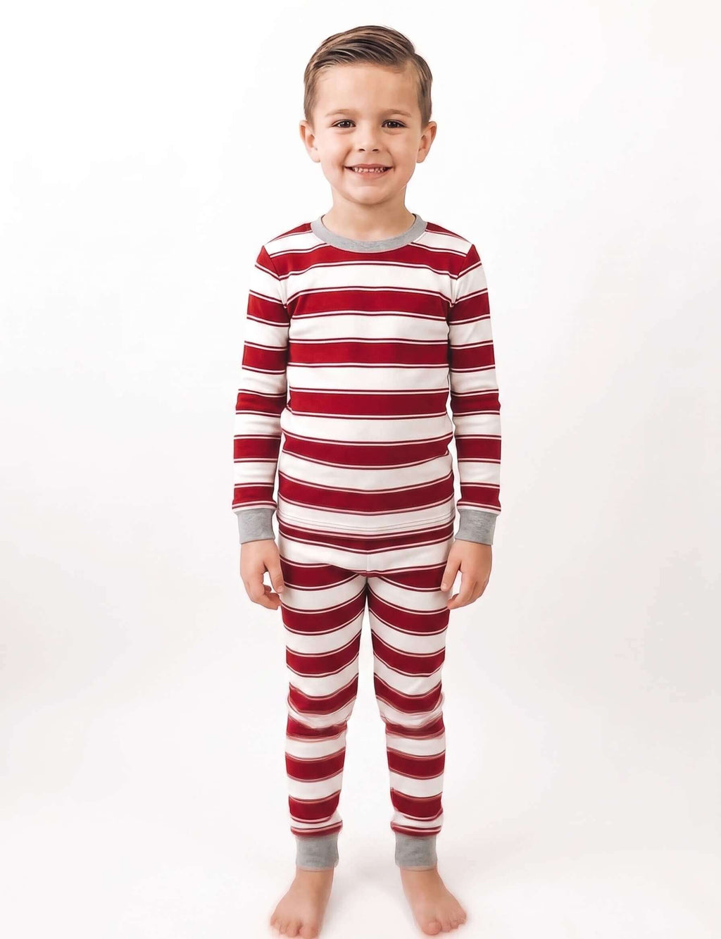 Family wearing matching red and white striped Christmas pyjamas with grey ribbed cuffs - view 12