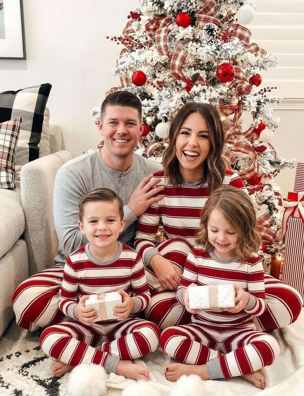 Family wearing matching red and white striped Christmas pyjamas with grey ribbed cuffs - view 5
