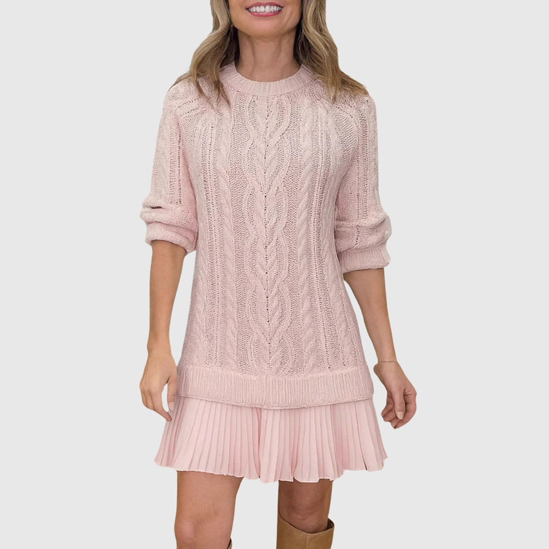Woman wearing a cable knit jumper dress with a crew neck, long sleeves and pleated mini hem - view 2