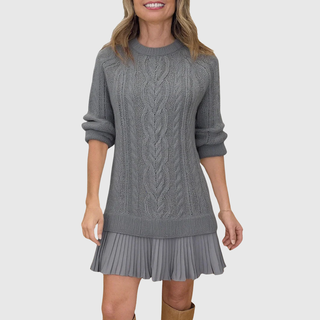 Woman wearing a cable knit jumper dress with a crew neck, long sleeves and pleated mini hem - view 4