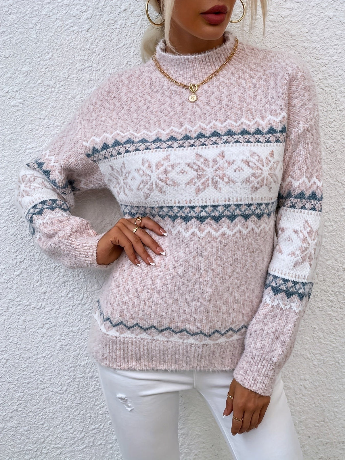 Woman wearing a blue speckled Fair Isle snowflake mock neck jumper with white jeans - view 11