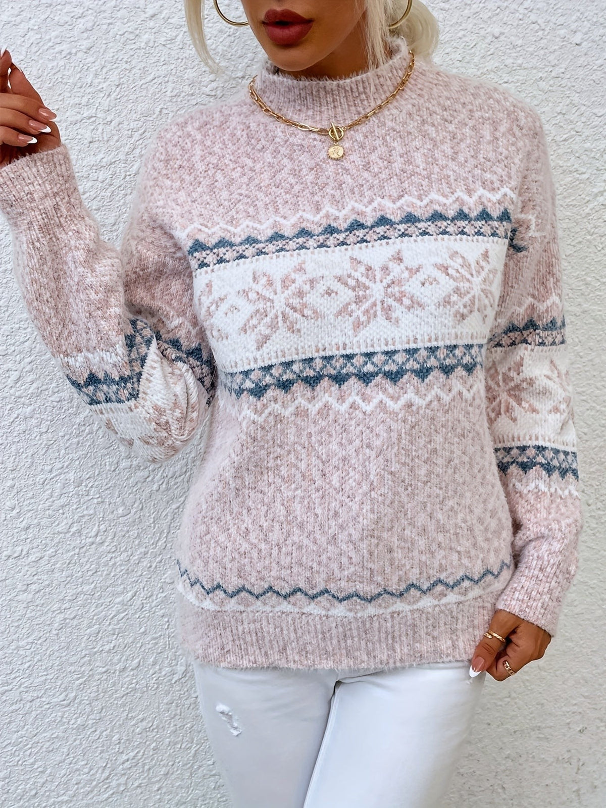 Woman wearing a blue speckled Fair Isle snowflake mock neck jumper with white jeans - view 12