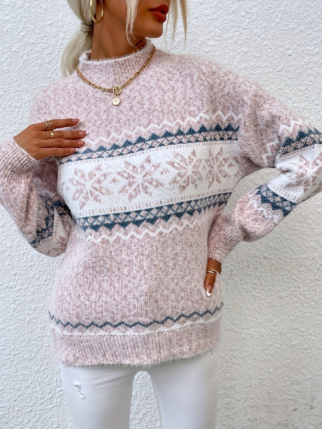 Woman wearing a blue speckled Fair Isle snowflake mock neck jumper with white jeans - view 13