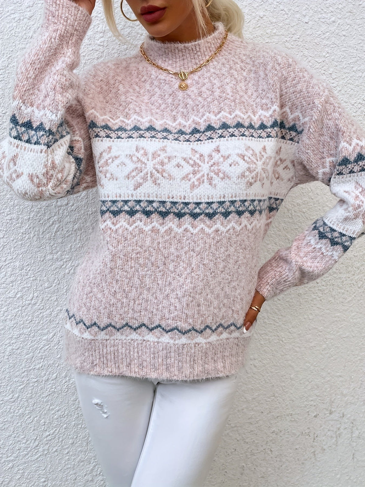 Woman wearing a blue speckled Fair Isle snowflake mock neck jumper with white jeans - view 14
