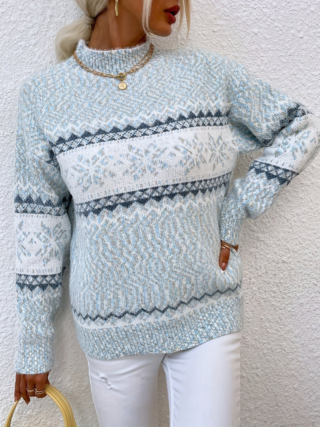 Woman wearing a blue speckled Fair Isle snowflake mock neck jumper with white jeans - view 21
