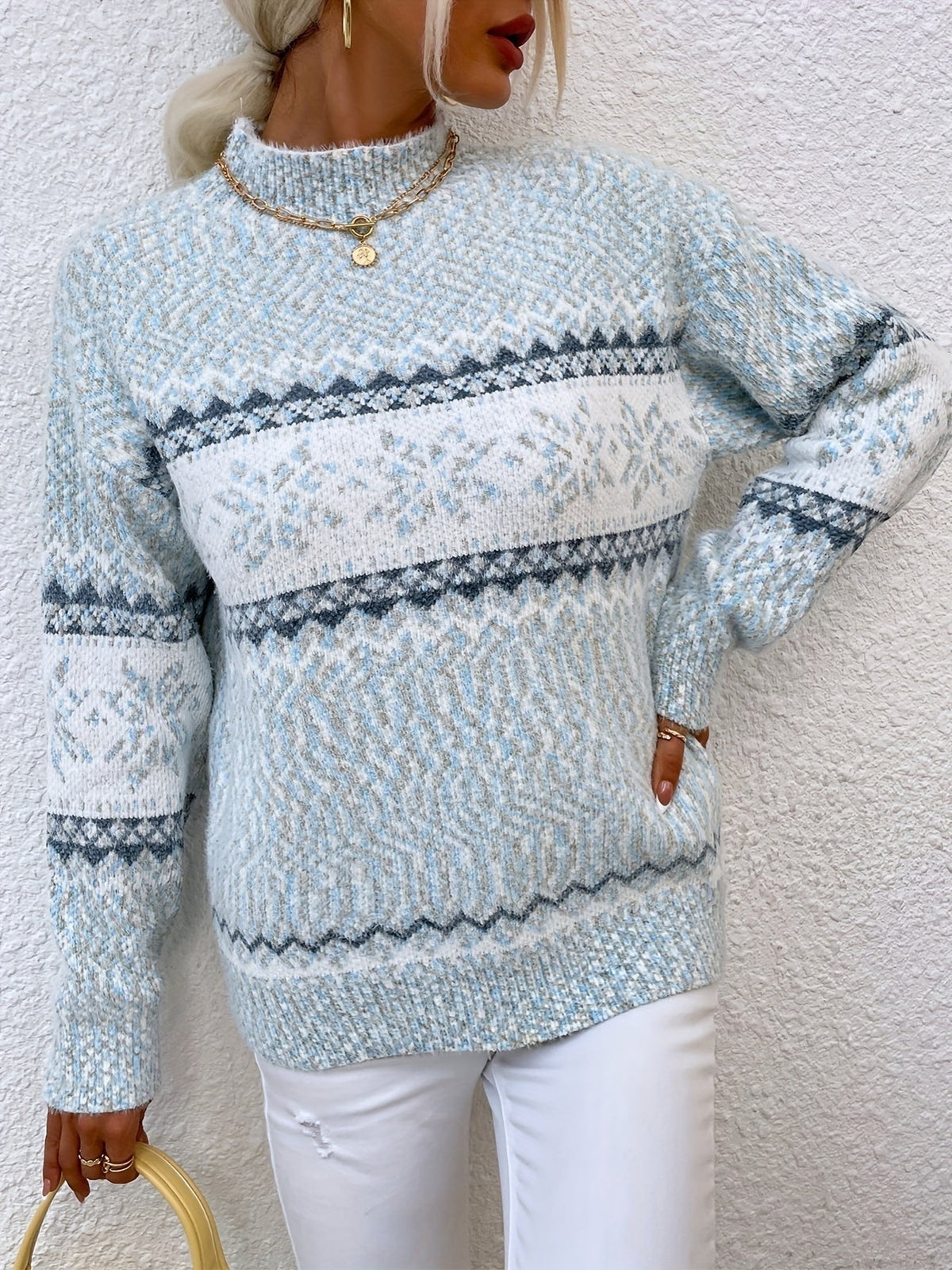 Woman wearing a blue speckled Fair Isle snowflake mock neck jumper with white jeans - view 21