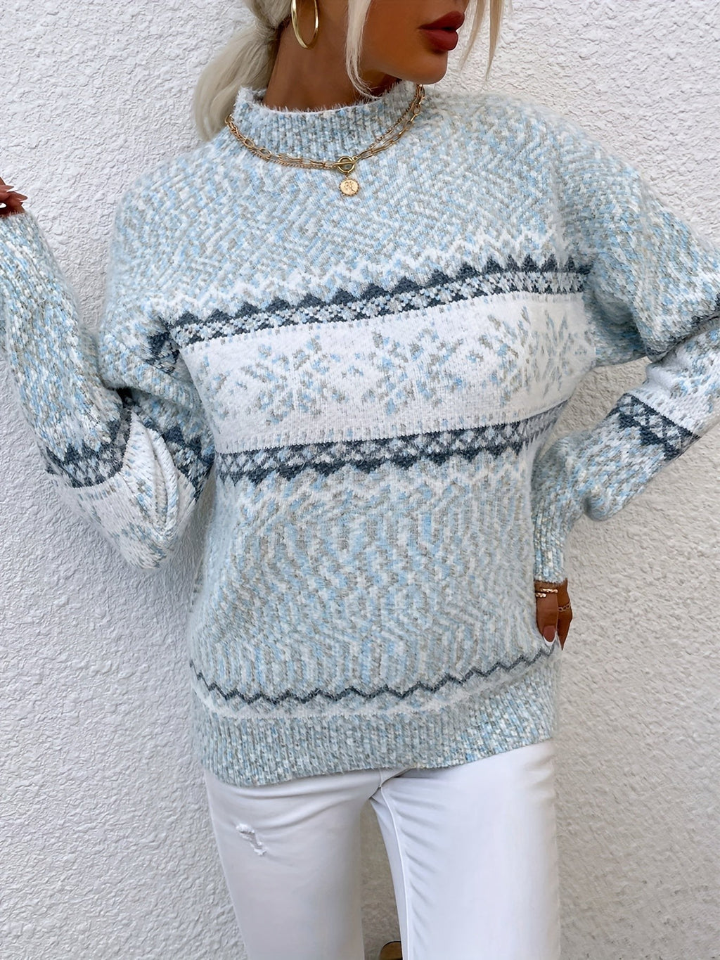 Woman wearing a blue speckled Fair Isle snowflake mock neck jumper with white jeans - view 23