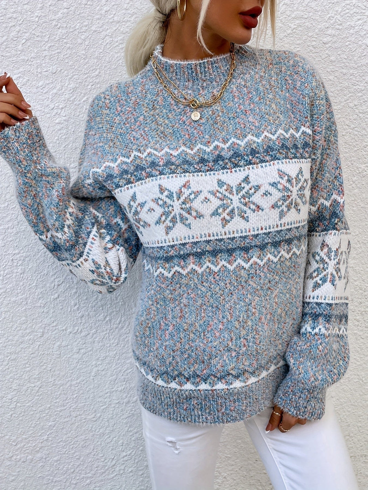 Woman wearing a blue speckled Fair Isle snowflake mock neck jumper with white jeans - view 5
