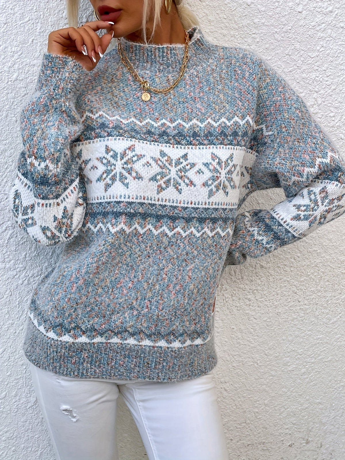 Woman wearing a blue speckled Fair Isle snowflake mock neck jumper with white jeans - view 7