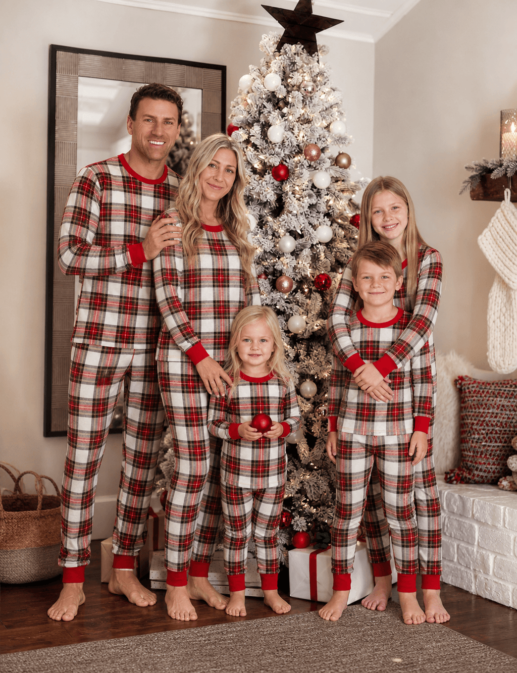 Family wearing matching red and cream tartan Christmas pyjamas with red ribbed cuffs - view 2