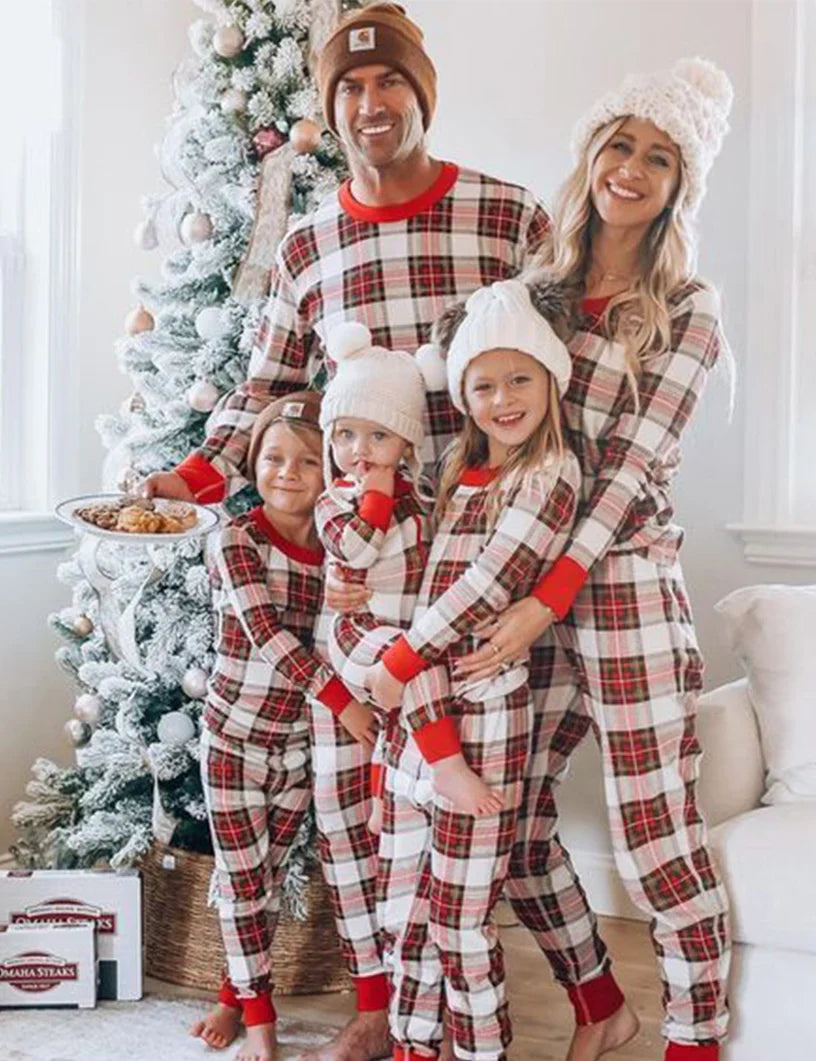 Family wearing matching red and cream tartan Christmas pyjamas with red ribbed cuffs - view 3