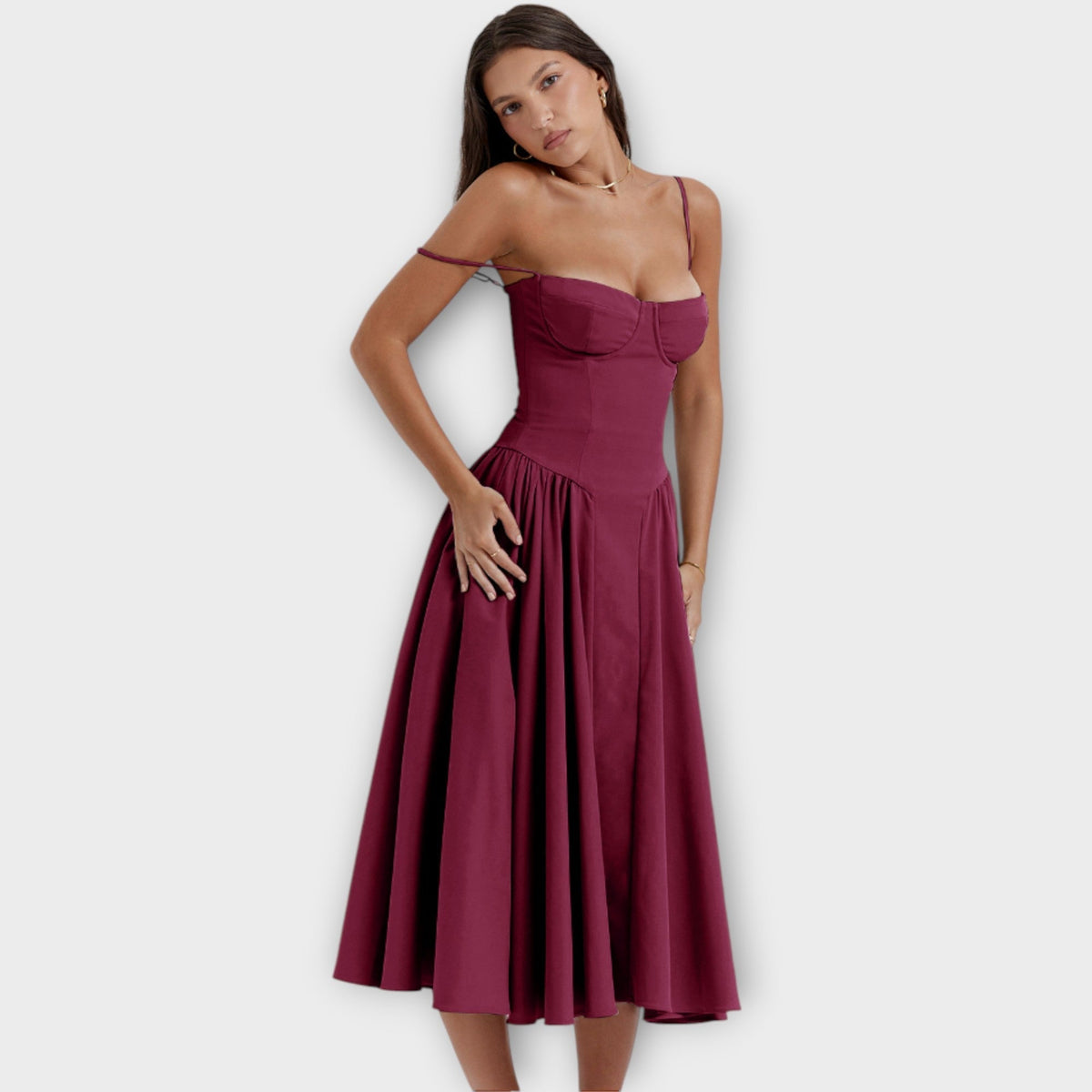 Woman wearing a sleeveless sweetheart corset midi dress with spaghetti straps and a full gathered skirt - view 9