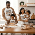 Matching family Christmas pyjamas with Cookie Baking Crew slogan top and gingerbread print trousers