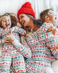 Matching family Christmas pyjamas with red and green reindeer Fair Isle print and grey cuffs