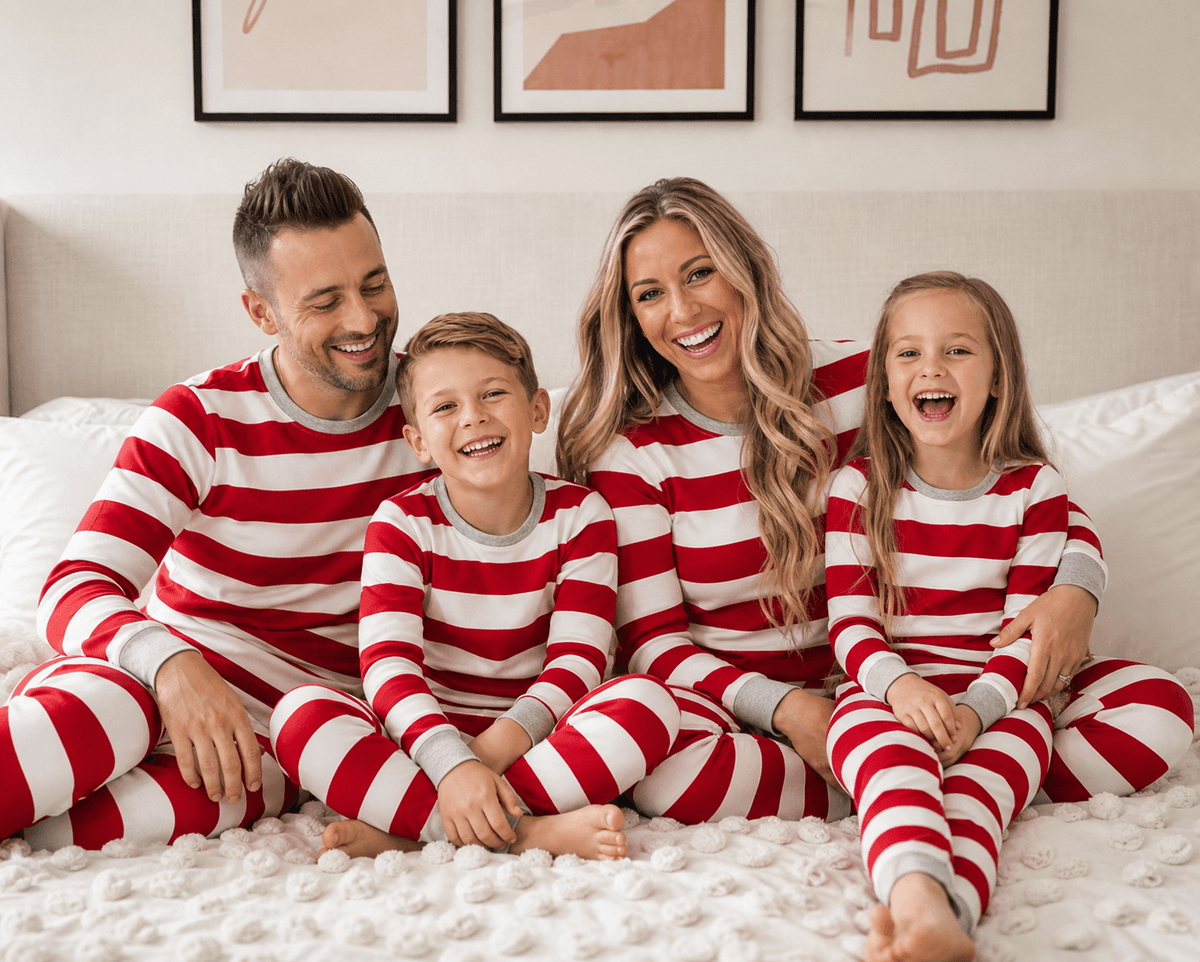 Family wearing matching red and white striped Christmas pyjamas with grey cuffs - view 3