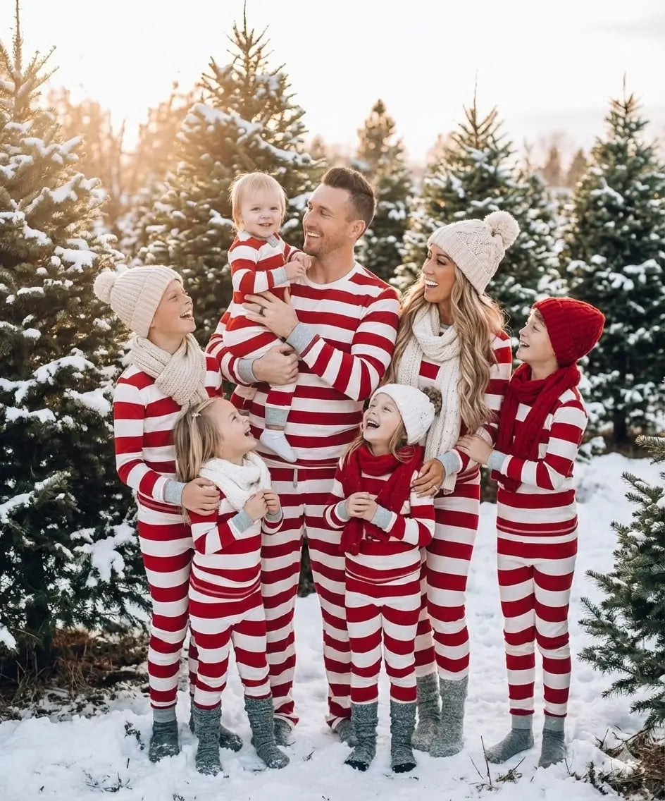 Family wearing matching red and white striped Christmas pyjamas with grey cuffs - view 5