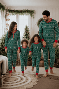 Family wearing matching green Christmas tree print pyjamas with red cuffs