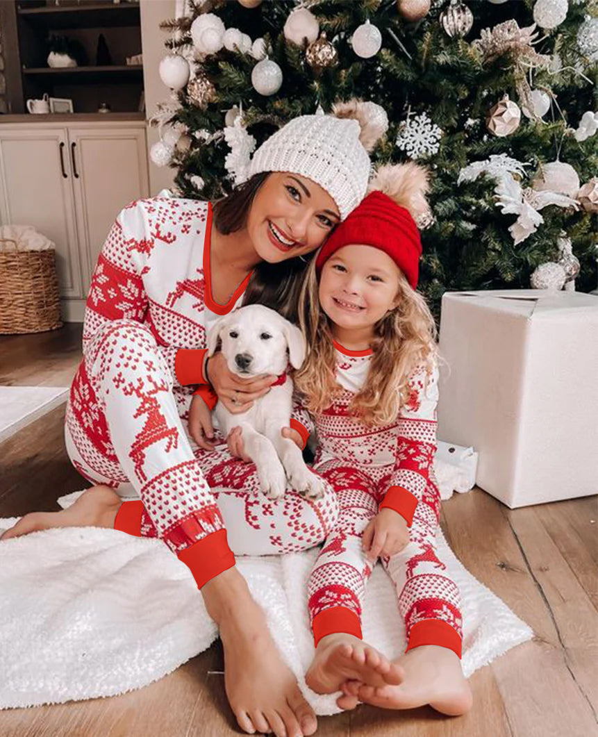Matching family Christmas pyjamas with red reindeer and snowflake print on white