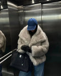 Grey faux fur jacket with oversized collar worn open over jeans