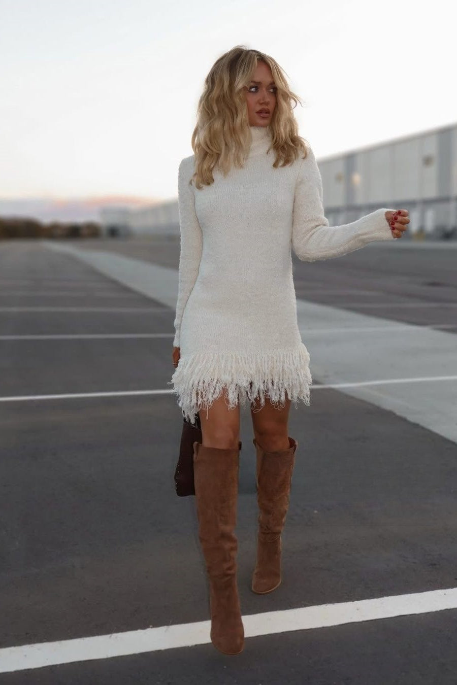 Woman wearing a fuzzy knit turtleneck jumper dress with long sleeves and a looped fringe hem - view 2