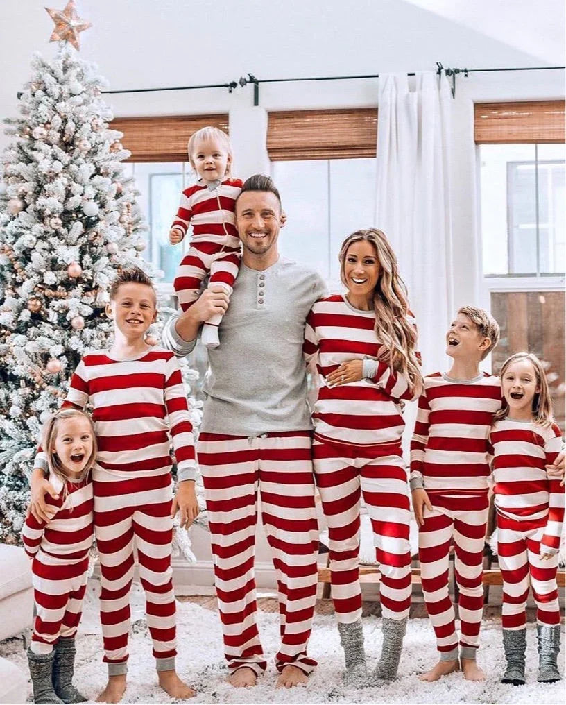 Family wearing matching red and white striped Christmas pyjamas with grey ribbed cuffs - view 5
