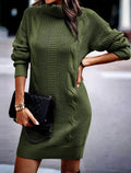 Woman wearing a cable knit roll neck jumper dress in mini length with long sleeves