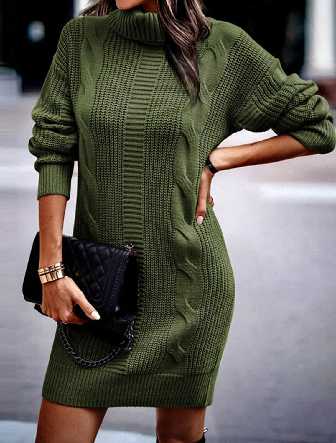 Woman wearing a cable knit roll neck jumper dress in mini length with long sleeves
