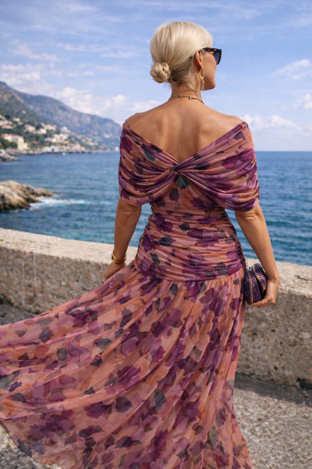 Woman wearing a draped off-shoulder maxi party dress with ruched waist and sheer flowing skirt - view 11