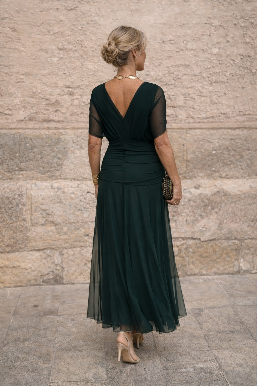 Woman wearing a draped off-shoulder maxi party dress with ruched waist and sheer flowing skirt - view 7