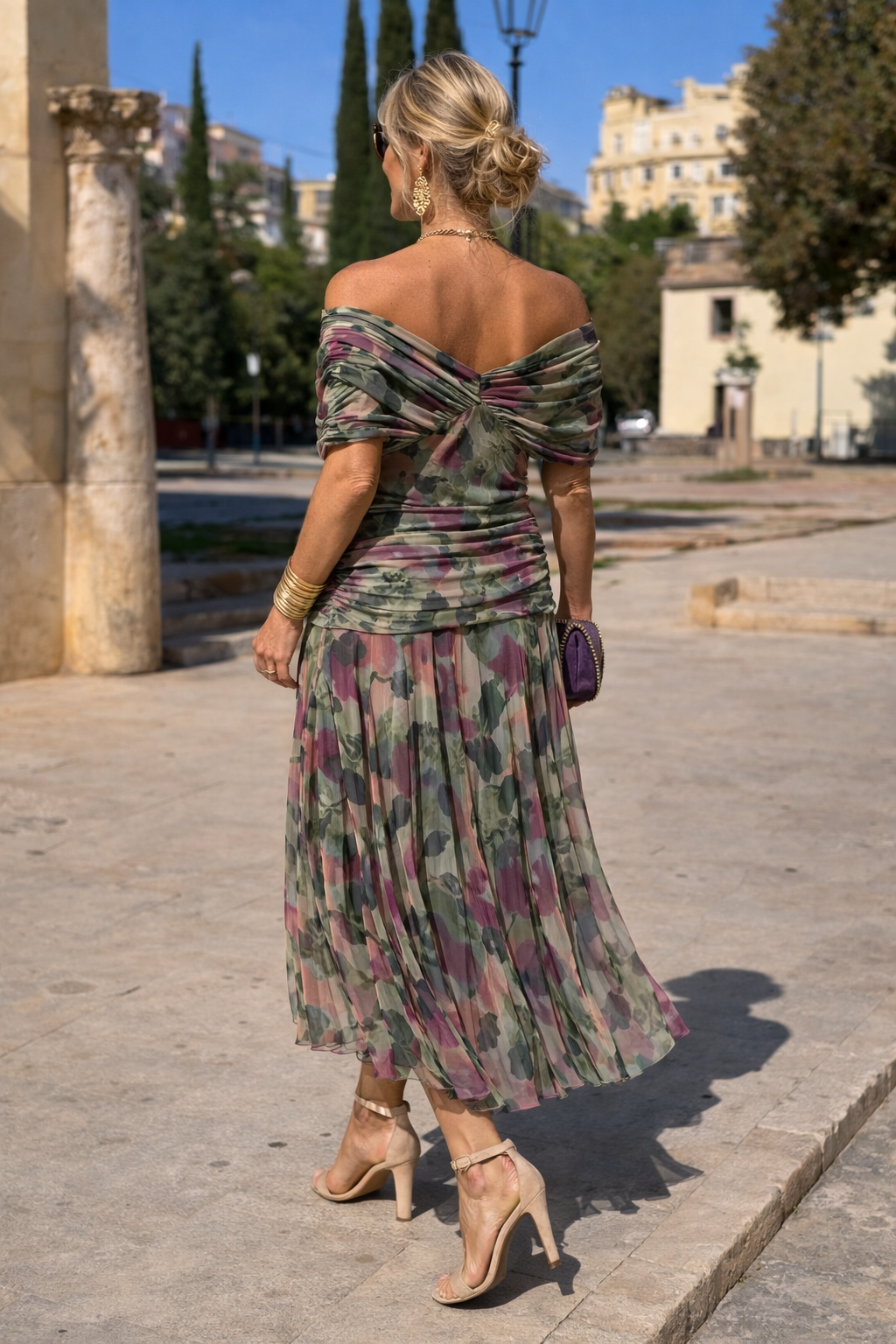 Woman wearing a draped off-shoulder maxi party dress with ruched waist and sheer flowing skirt - view 9